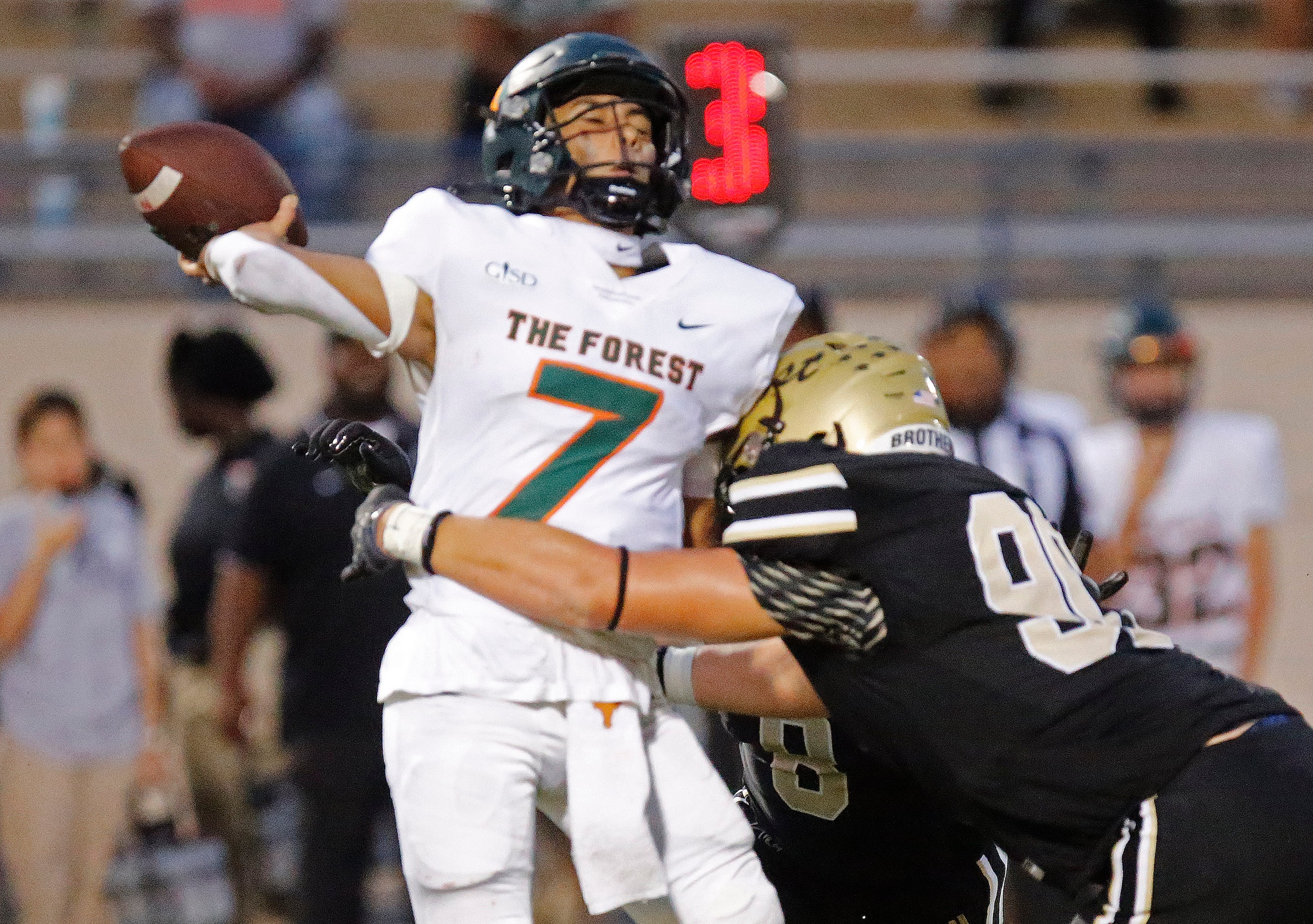 Naaman Forrest High School quarterback Deangelo Perales (7) got an intentional grounding...