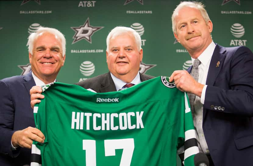 Ken Hitchcock poses for a photo with team president Jim Lites (left) and general manager Jim...