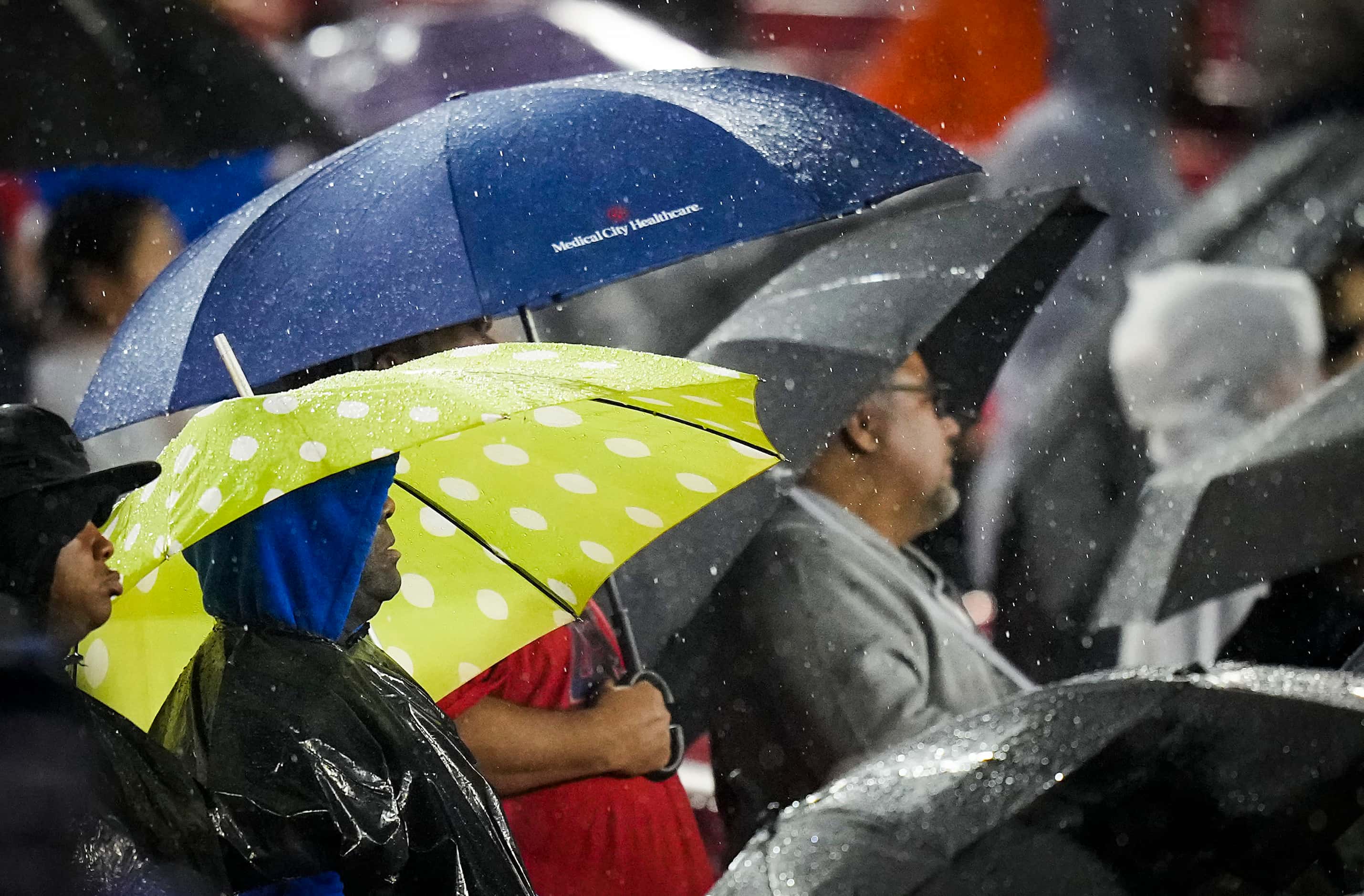 Duncanville fans try to stay dry during the first half of a Class 6A Division I state...