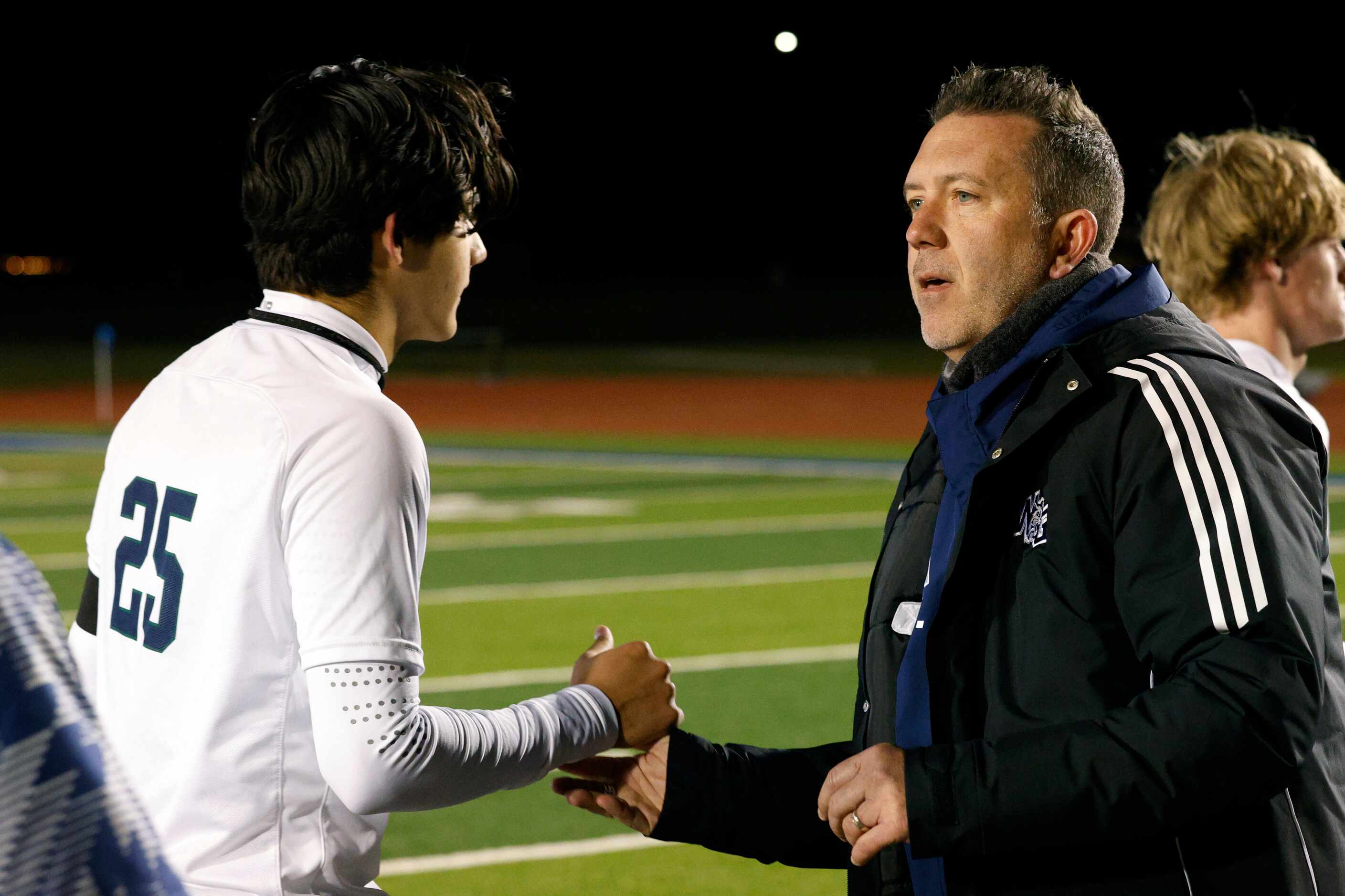 Prosper Walnut Grove head coach Trent Kutch greets Frisco Reedy's Ansel Rosato (25) after a...