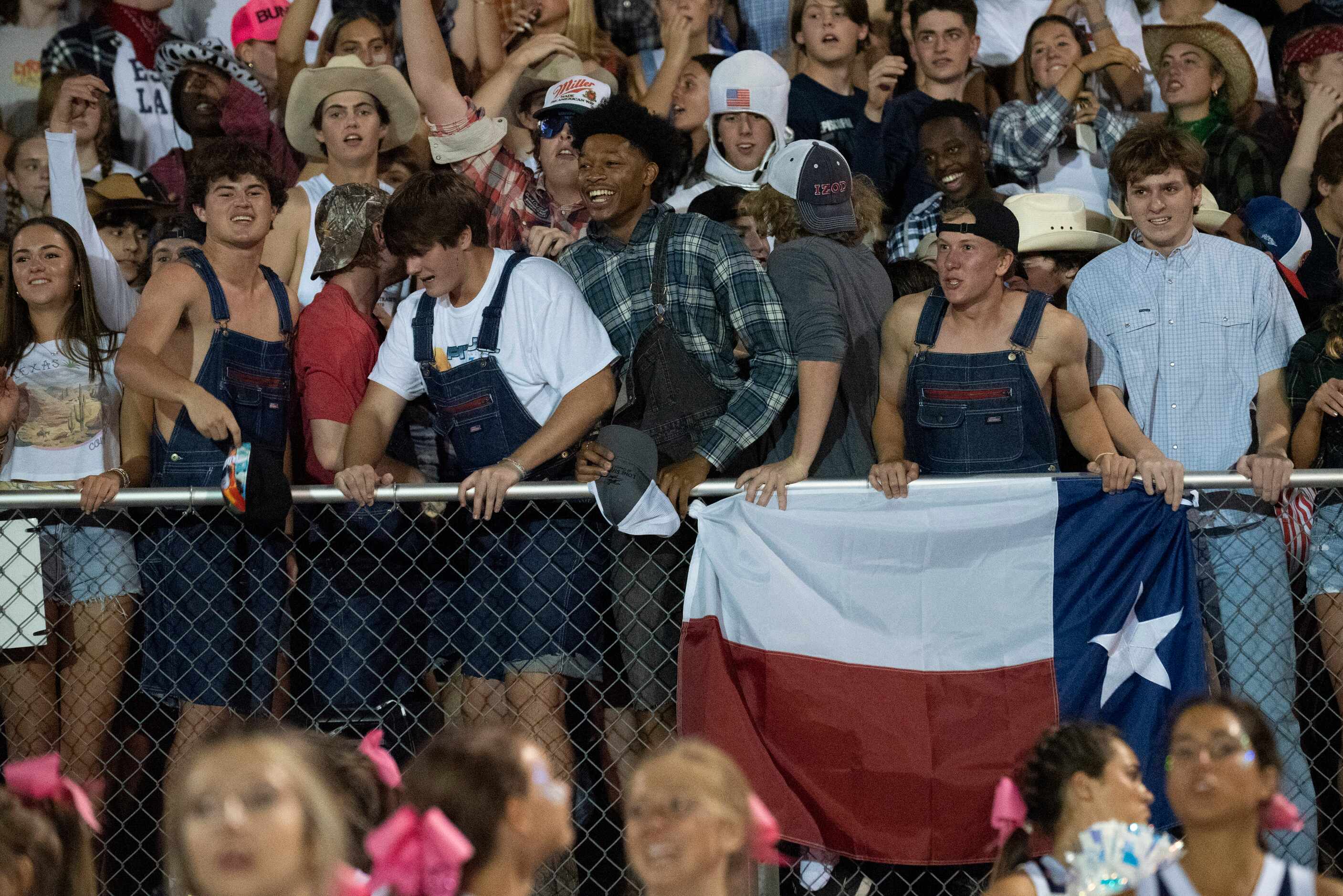 Episcopal School of Dallas students jump while chanting for their team during the second...