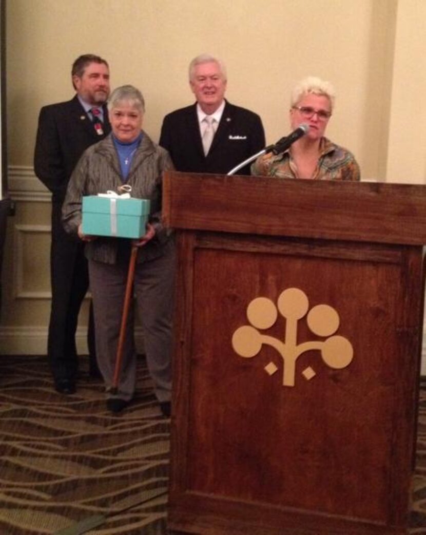 
Patty Bozeman, holding blue box, accepts award on behalf of her late husband Gnat Bozeman
