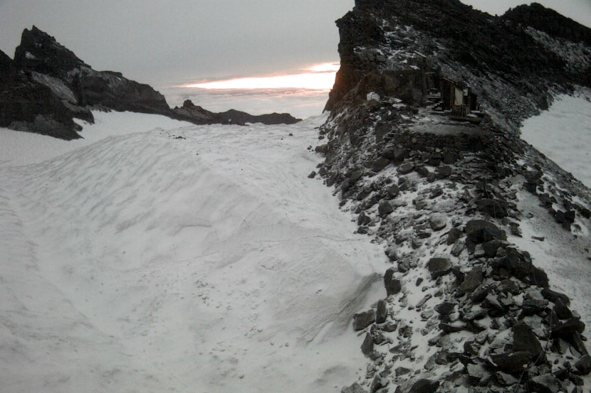 This photo provided by the National Weather Service shows a snow-covered section of Mt....