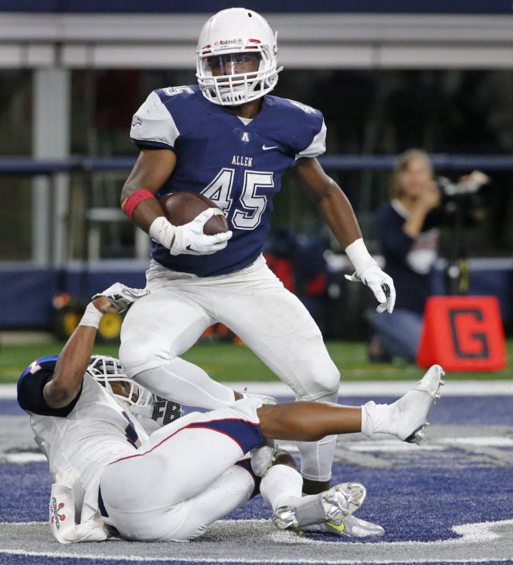 Allen running back Kirby Bennett (45) scores despite the efforts of Denton Ryan's Randy Gray...