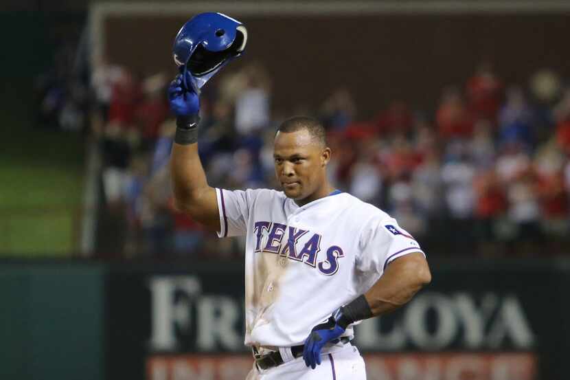 Texas third baseman Adrian Beltre tips his hat to the crowd after he hit for the cycle...