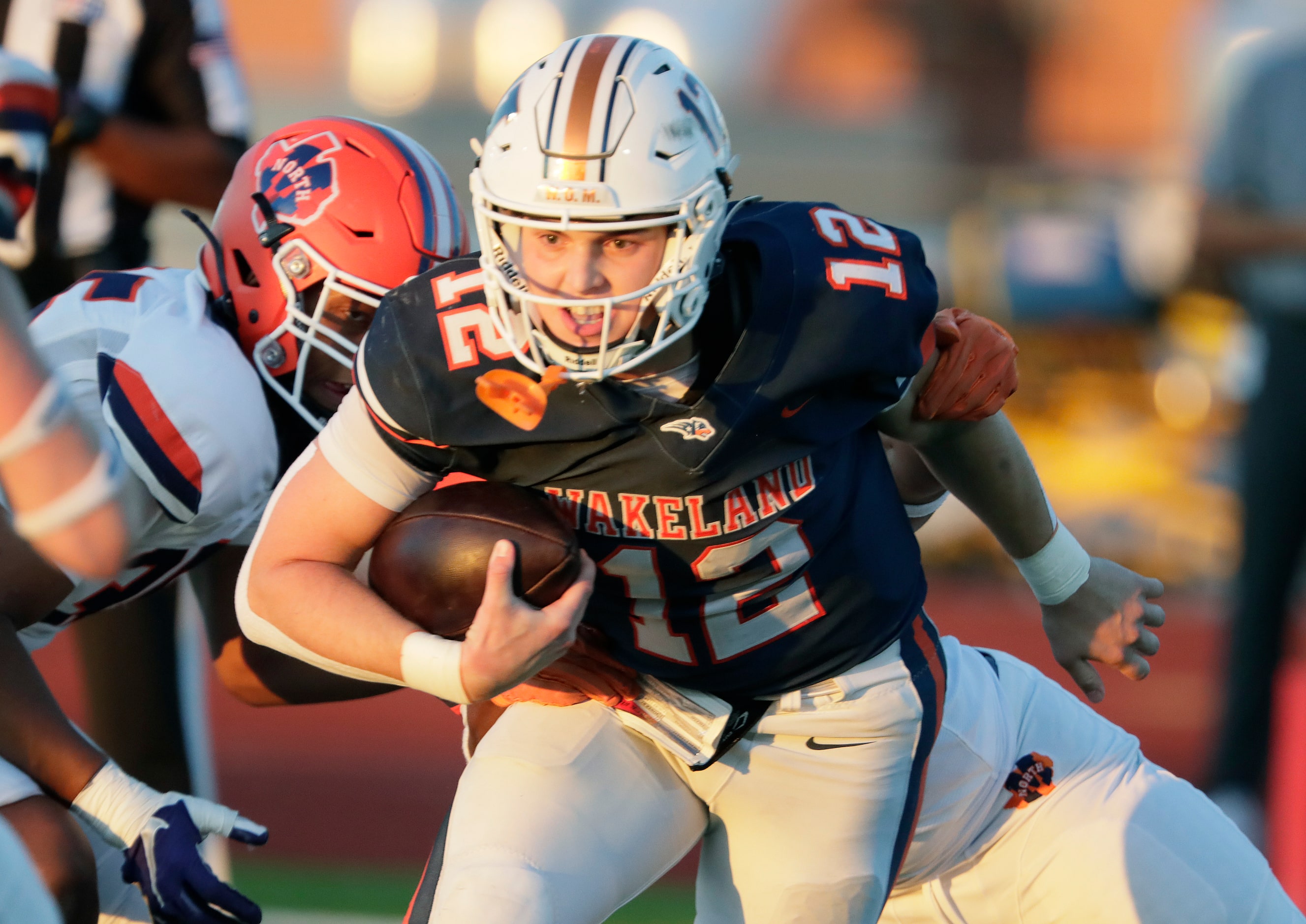 Wakeland High School quarterback Jayden Maples (12) is wrapped up after a missed snap during...