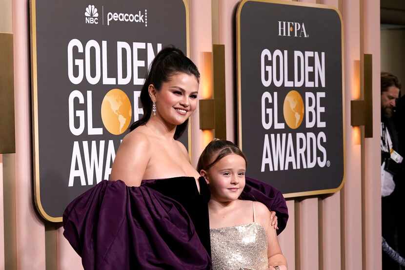Selena Gomez, left, and Gracie Elliott Teefey arrive at the 80th annual Golden Globe Awards...