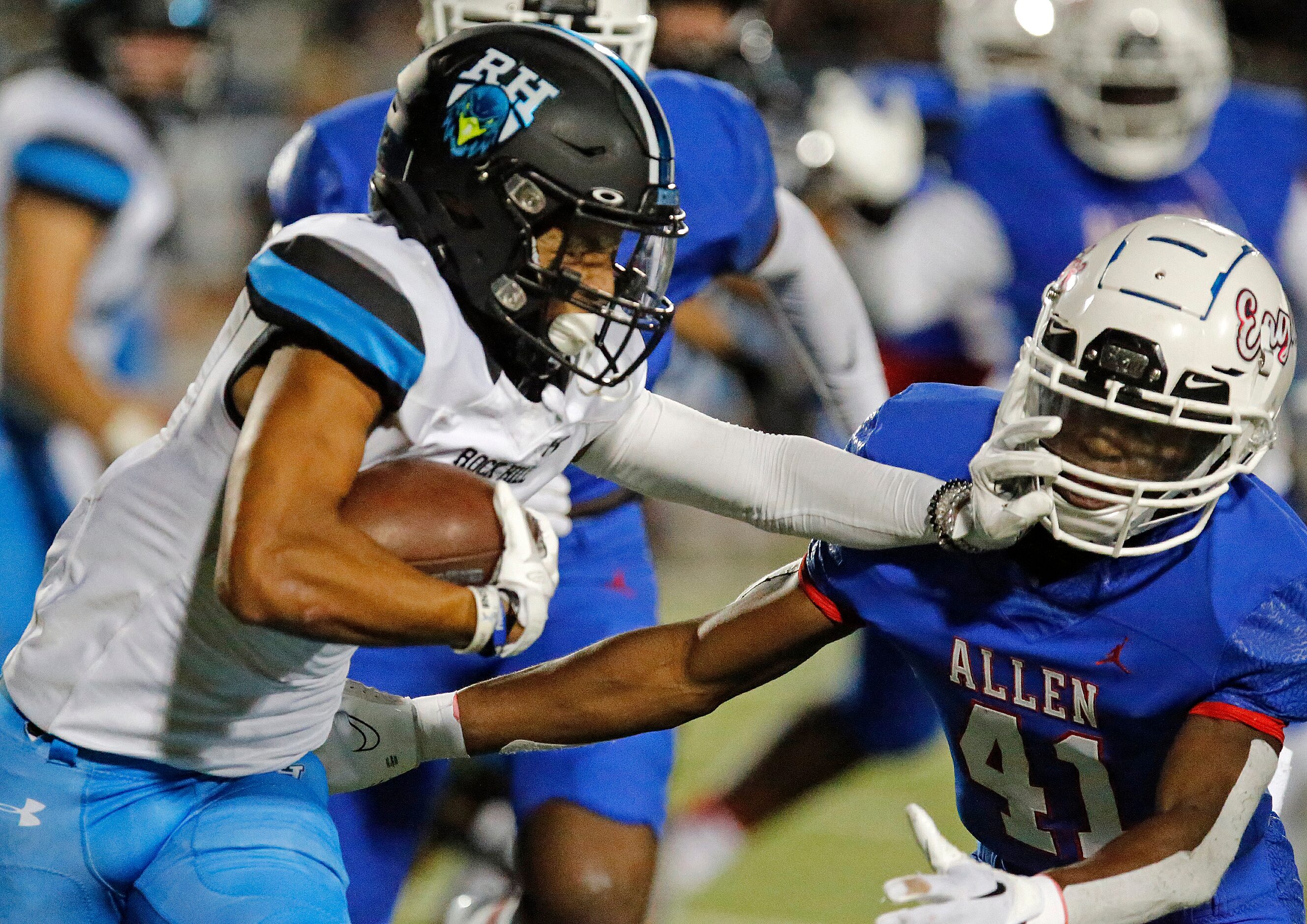 Rock Hill High School running back Victor Chionuma (2) stiff arms Allen High School...