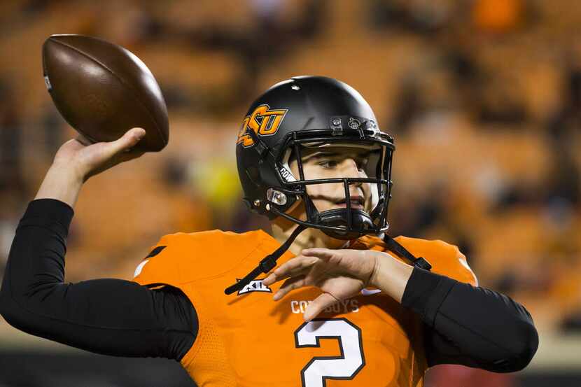 Oklahoma State quarterback Mason Rudolph warms up before an NCAA football game against...