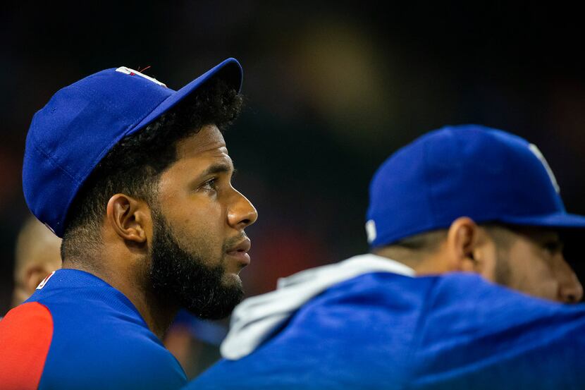 Texas Rangers shortstop Elvis Andrus watches from the dugout during the ninth inning of a...