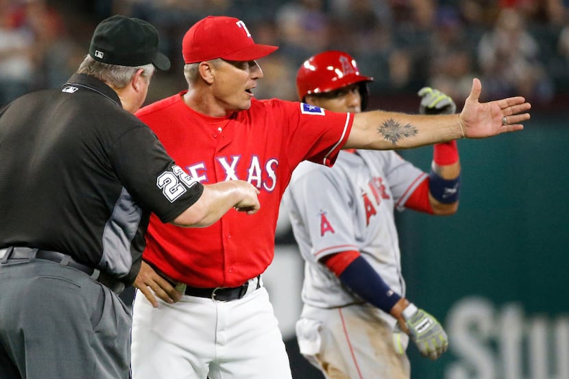 Second base umpire Joe West ejects Texas Rangers manager Jeff Banister (28) as he argues a...