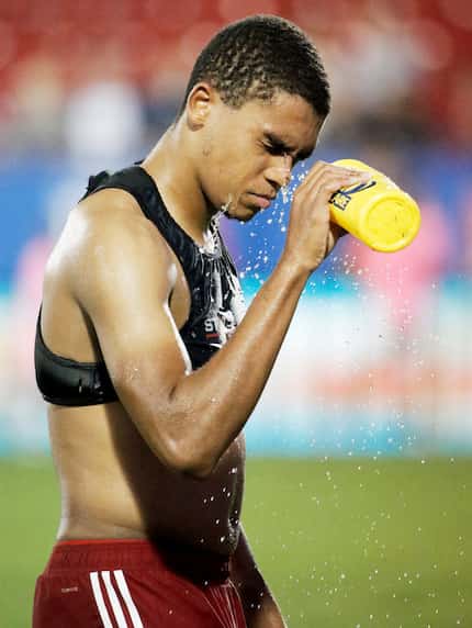 FC Dallas defender Reggie Cannon splashes water onto his face after an MLS soccer match...
