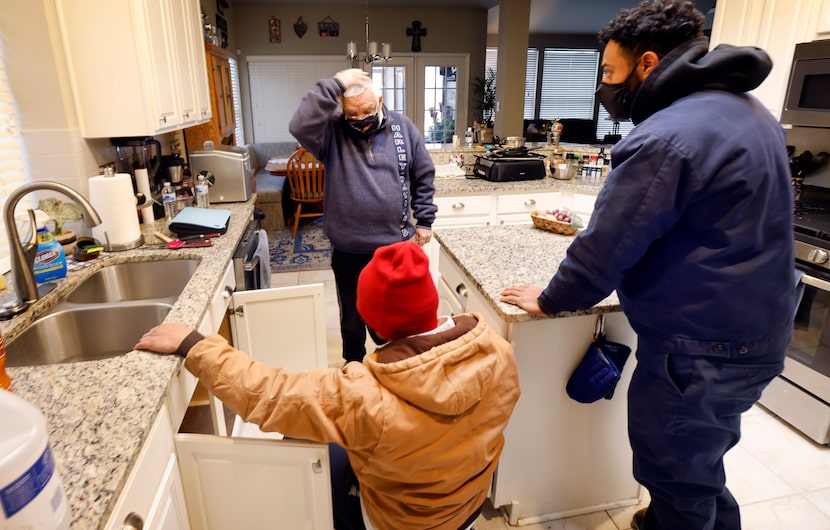 Homeowner Joe Ellery listened as plumbers Geovanni 'Geo' Marino (center) and Nick Paulk of...