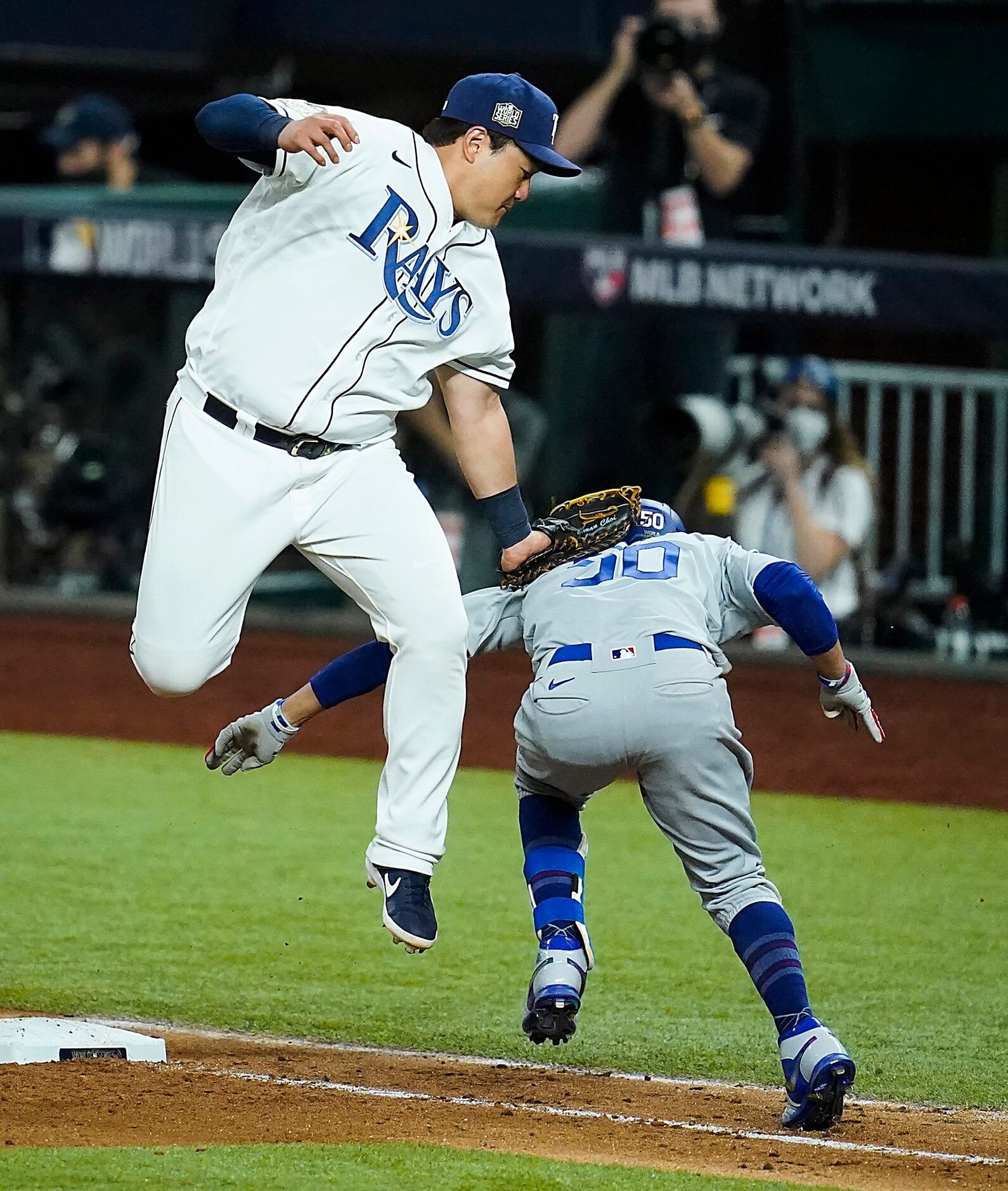 Tampa Bay Rays first baseman Ji-Man Choi makes a leaping catch and swipe to put the tag Los...