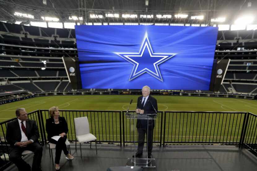 Dallas Cowboys owner Jerry Jones, right, speaks as ATT senior vice president Cathy Coughlin,...
