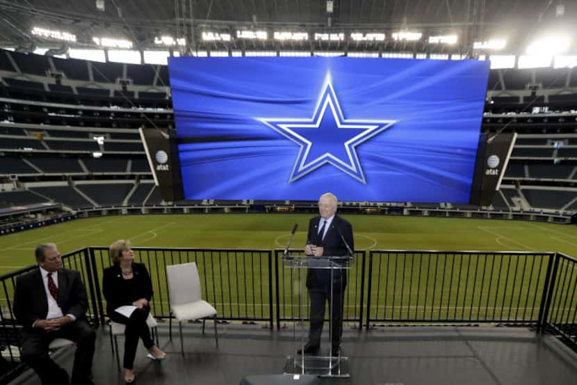 Dallas Cowboys owner Jerry Jones, right, speaks as ATT senior vice president Cathy Coughlin,...