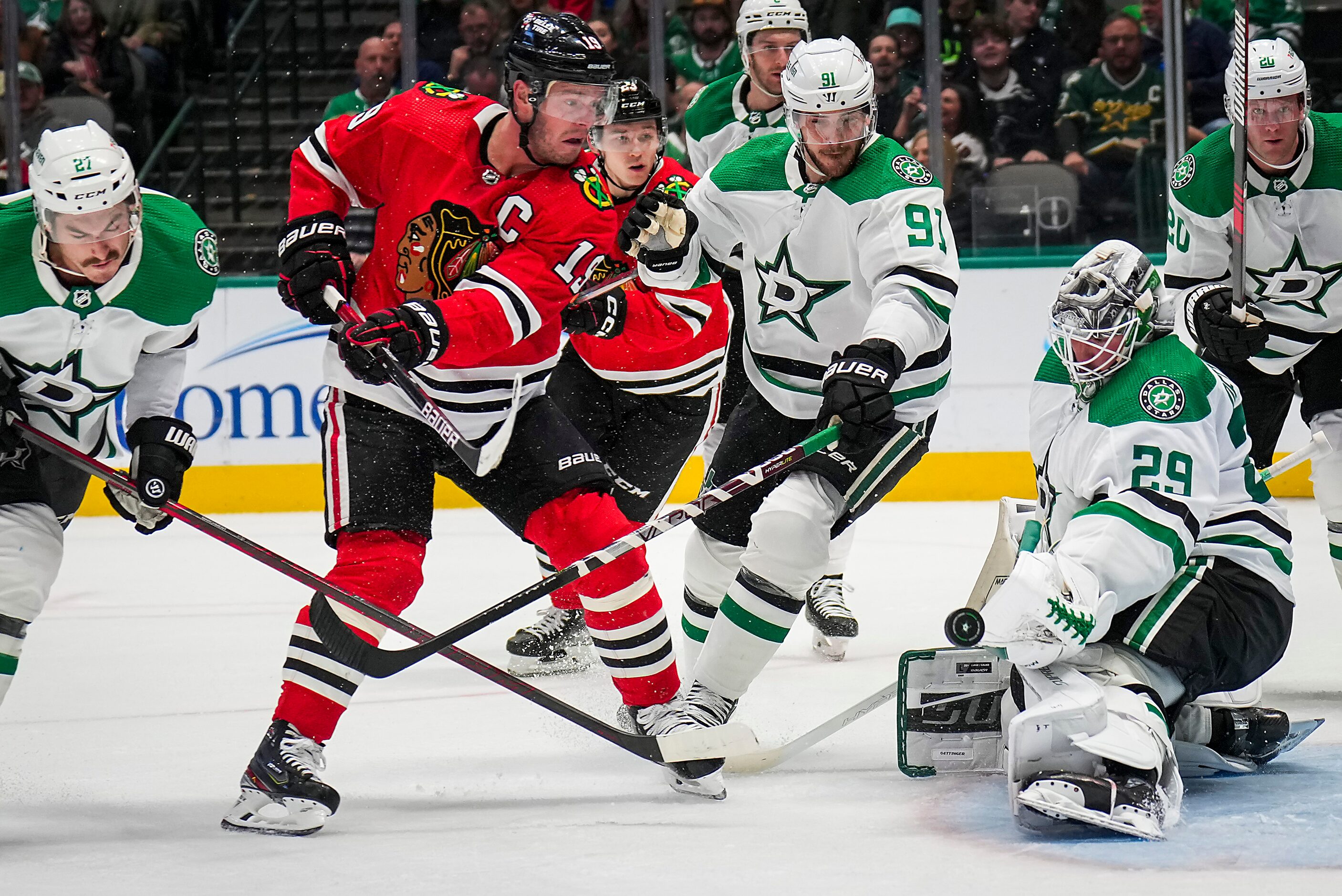 Dallas Stars goaltender Jake Oettinger (29) turns away Chicago Blackhawks left wing Boris...