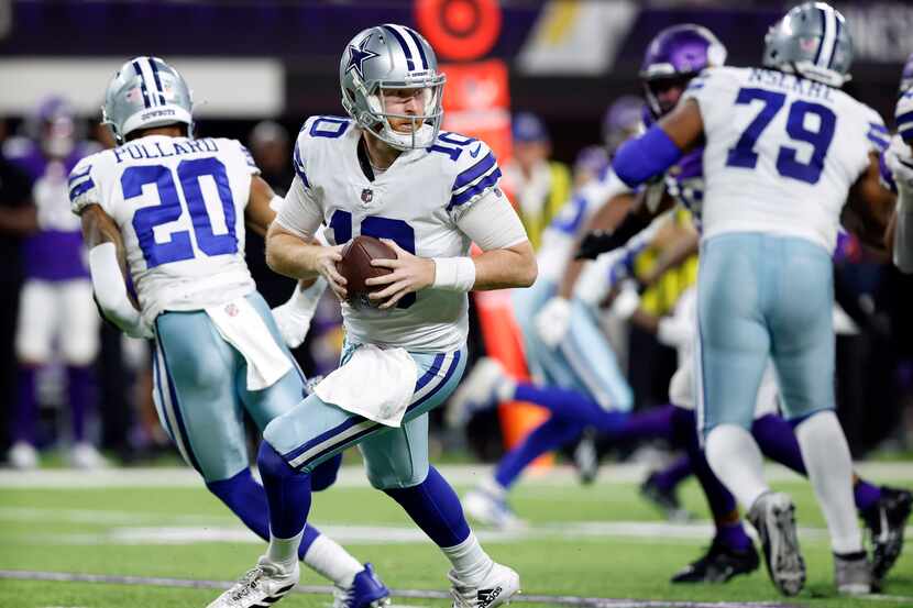 Dallas Cowboys quarterback Cooper Rush (10) rolls out of the pocket looking for a receiver...
