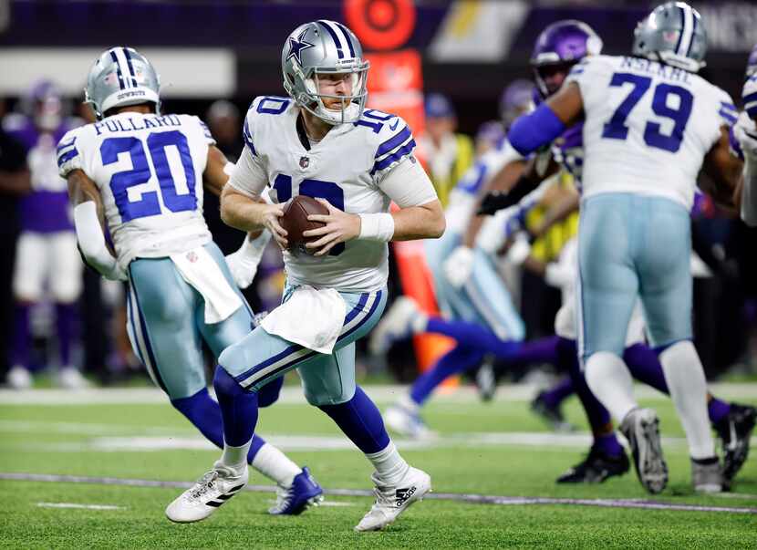 Dallas Cowboys quarterback Cooper Rush (10) rolls out of the pocket looking for a receiver...