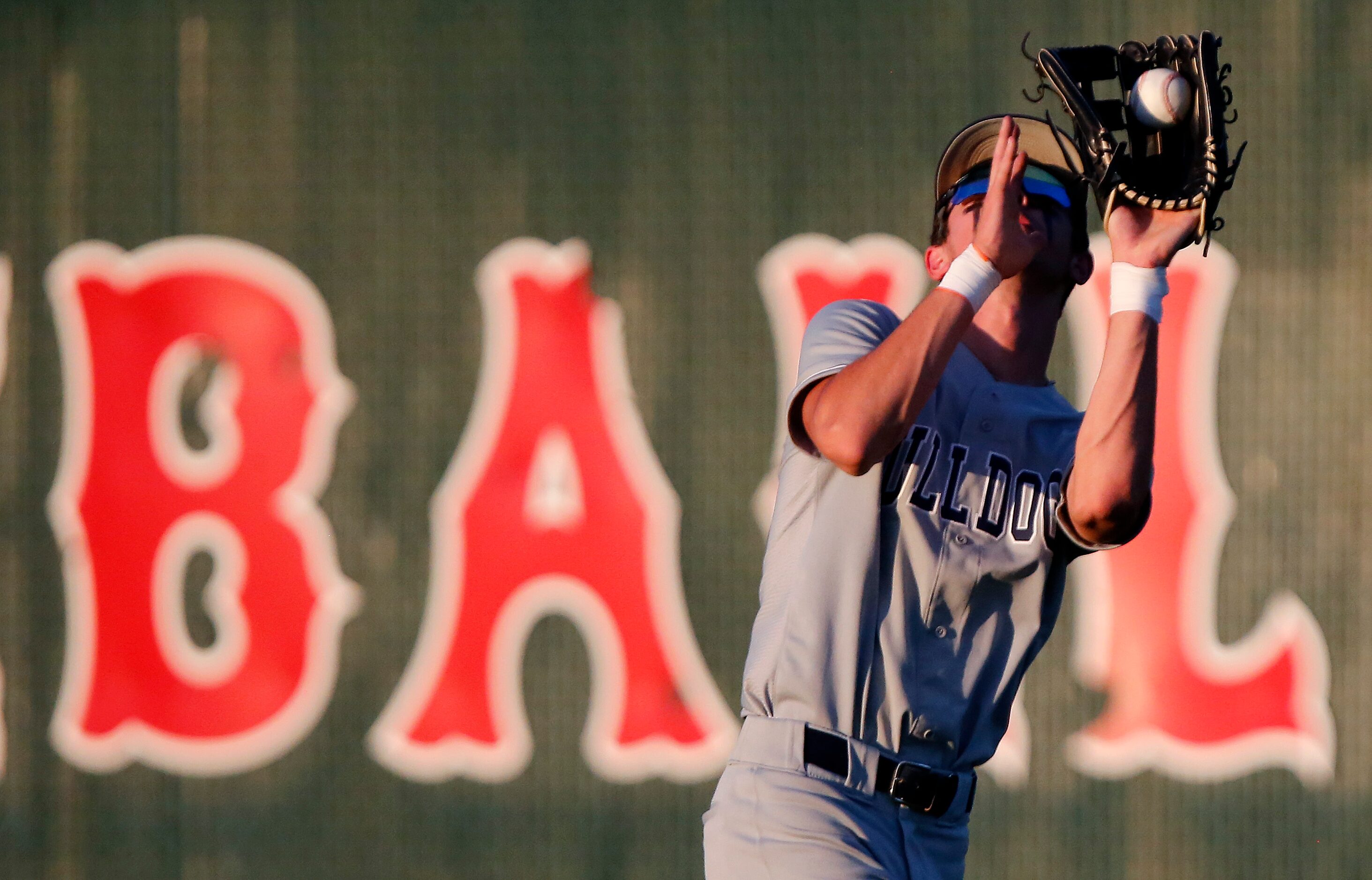 McKinney North High School right fielder Logan Laney (4) catches a pop fly in the third...