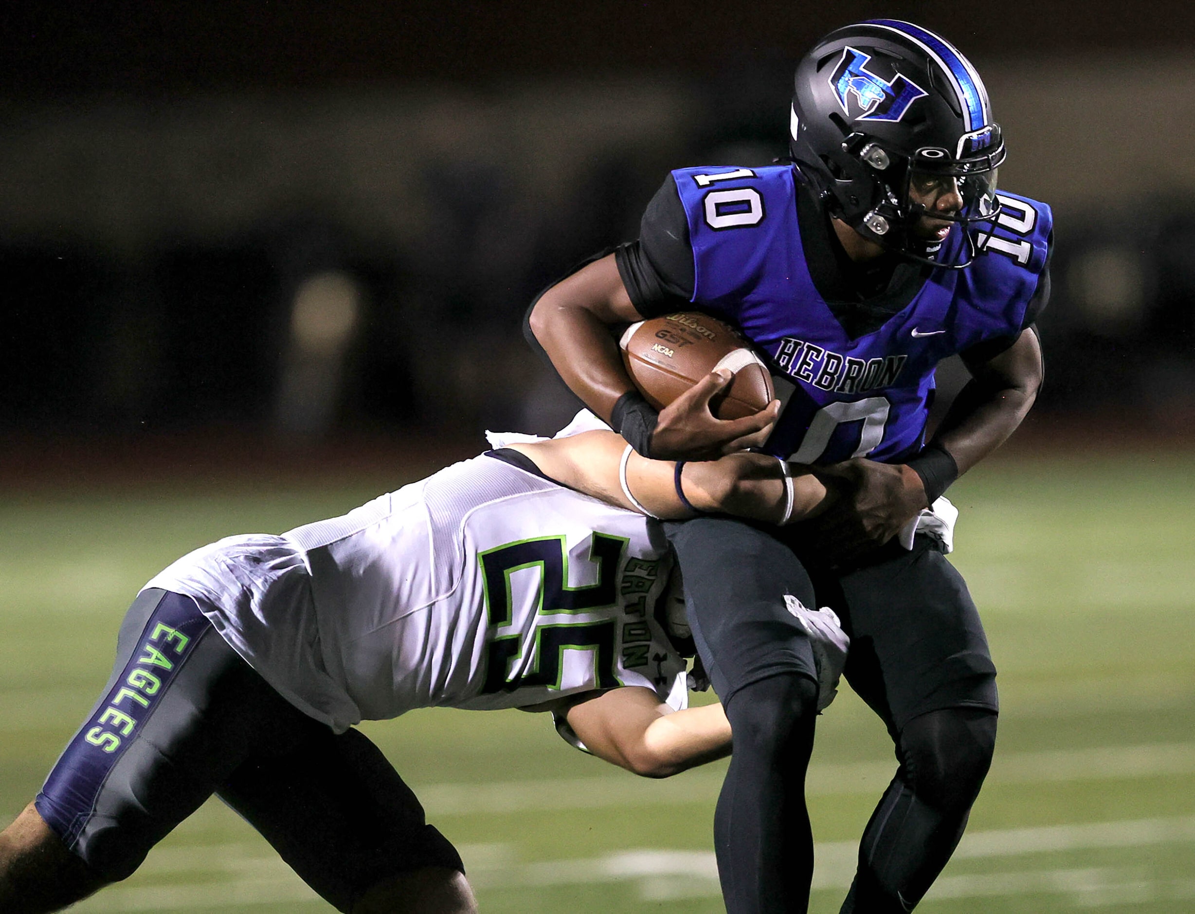 Hebron quarterback Patrick Crayton Jr (10) avoids getting sacked by Eaton linebacker Noah...