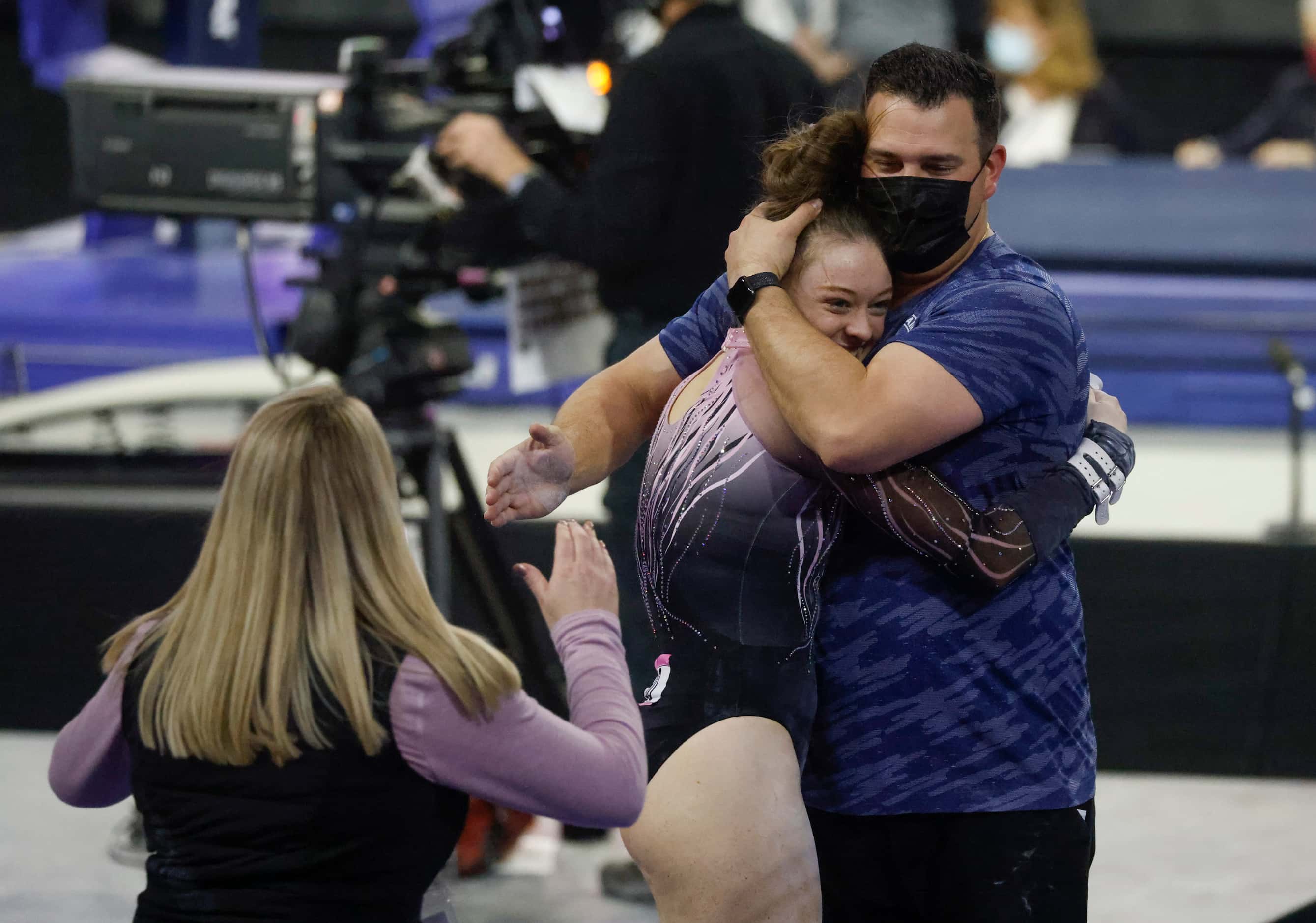 Abby Martin of Pearland Elite, Bacliff, Texas gets hugged by a gym official after...
