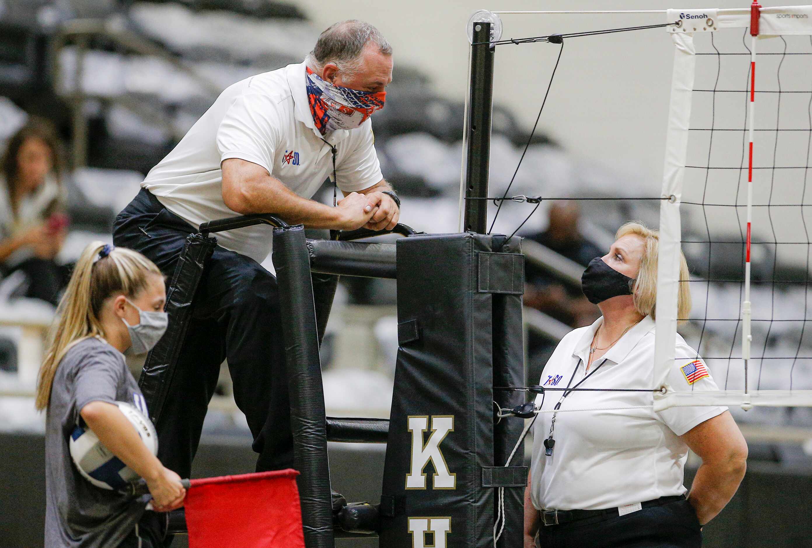 Officials Dee Davis, left, and Michele Bradshaw wear masks during a time out in play of a...