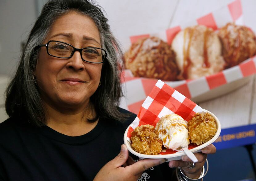 Denise Garza-De La Cruz holds up the arroz con leche, a cinnamon-spiced rice ball,...