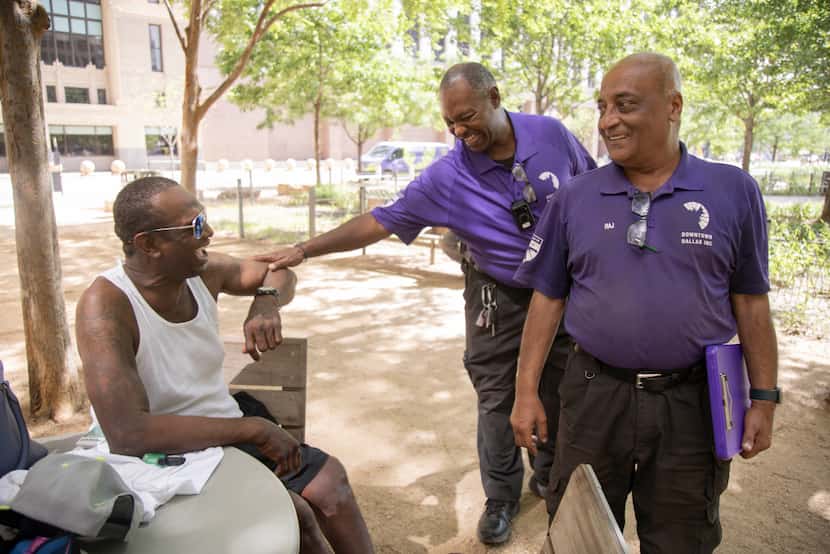 From left, Mark Anthony Bryant speaks to street outreach workers from Downtown Dallas, Inc....
