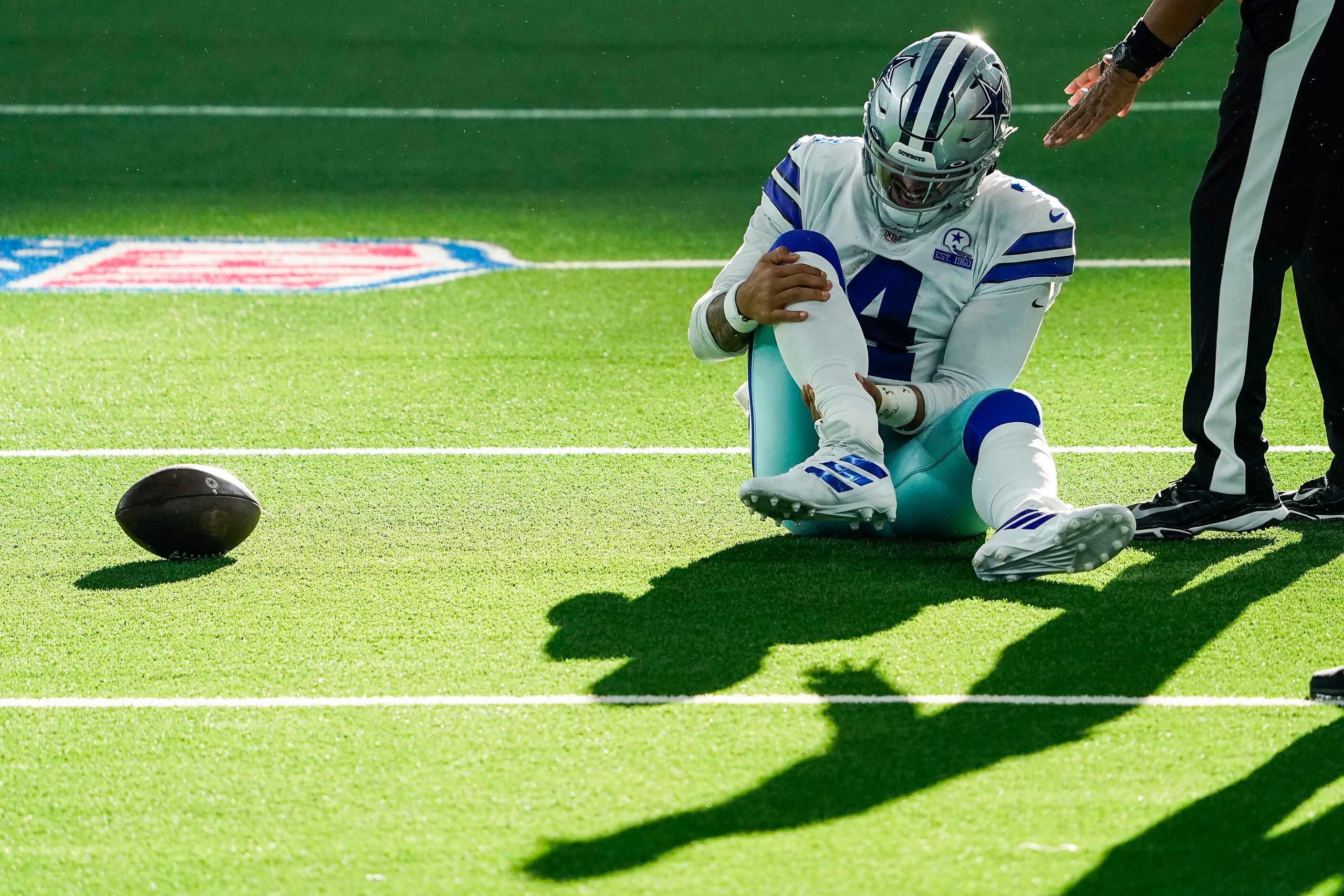 Dallas Cowboys quarterback Dak Prescott waits for medical attention after being injured on a...
