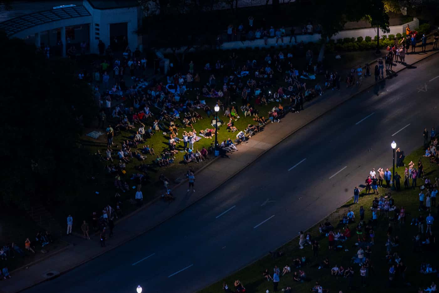 People watch from Dealey Plaza as the totality happens during the total solar eclipse viewed...