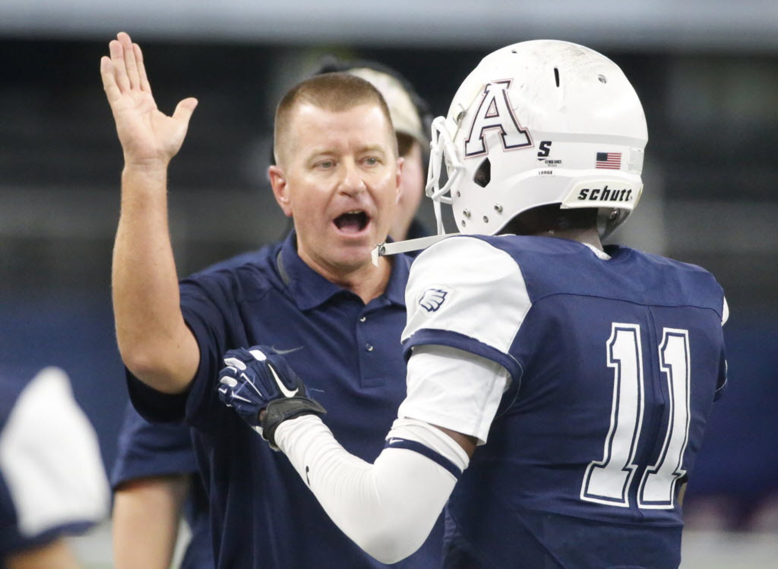 Allen head coach Tom Westerberg congratulates receiver Lionell McConnell (11) after an...