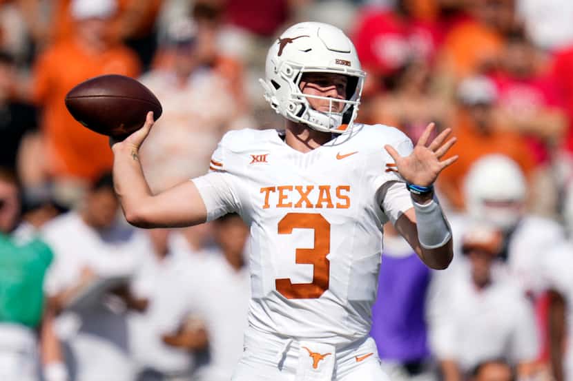Texas quarterback Quinn Ewers looks to throw a pass during the first half of an NCAA college...