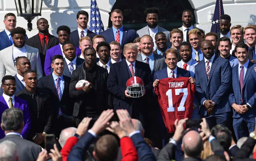 President Donald Trump, center, poses for a photos with the 2017 NCAA National Champion...