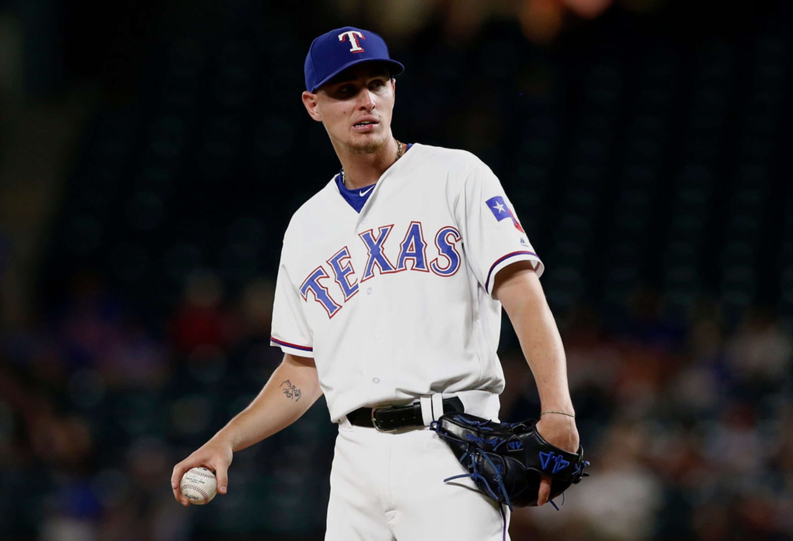 Texas Rangers' Carlos Tocci, normally an outfielder, prepares to pitch against the Oakland...