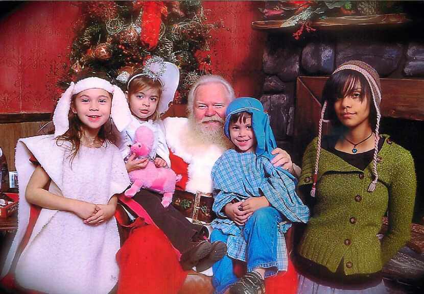 NorthPark Center Santa takes a photo with Marina Trahan Martinez's children in 2009. The...