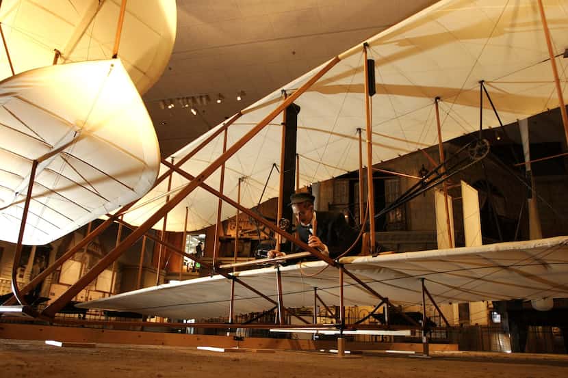 A likeness of Orville Wright lays at the controls in the Smithsonian Institution's National...