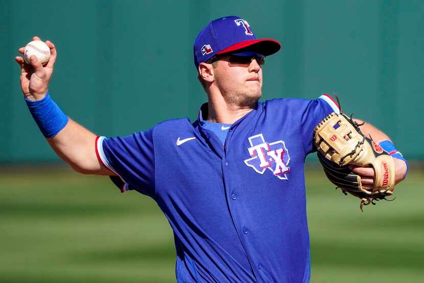 Texas Rangers third baseman Josh Jung makes a throw to first base during the fifth inning of...