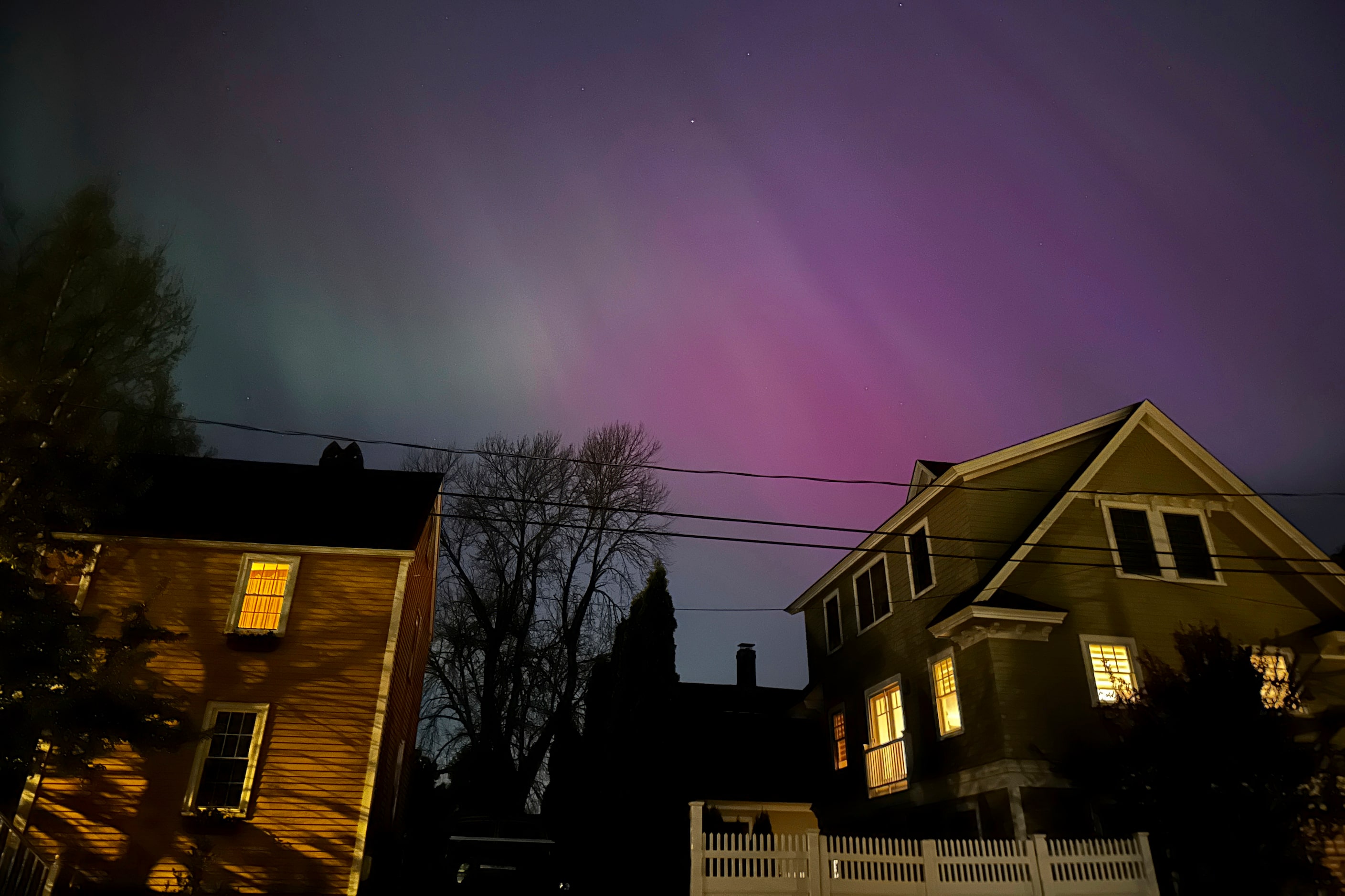 Northern lights shine over Portsmouth, N.H., Friday, May 10, 2024. Brilliant purple, green,...