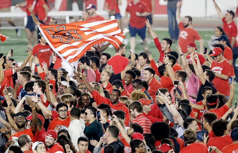 HOUSTON, TX - NOVEMBER 17: The Houston Cougars fans storm the field after the Cougars...