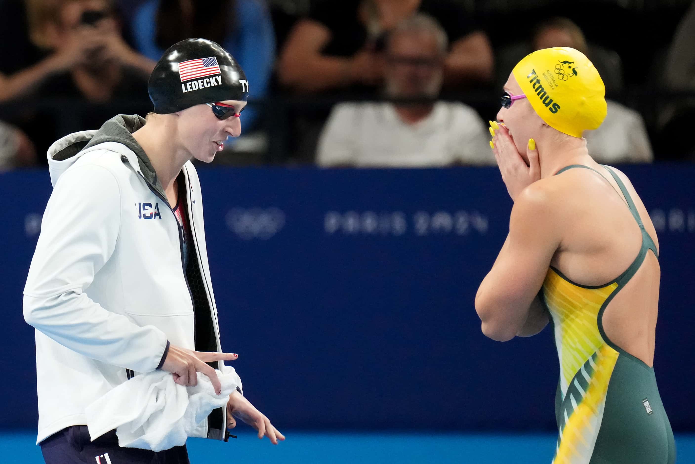 Ariarne Titmus (right) of Australia, and Katie Ledecky, of the United States, laugh after...