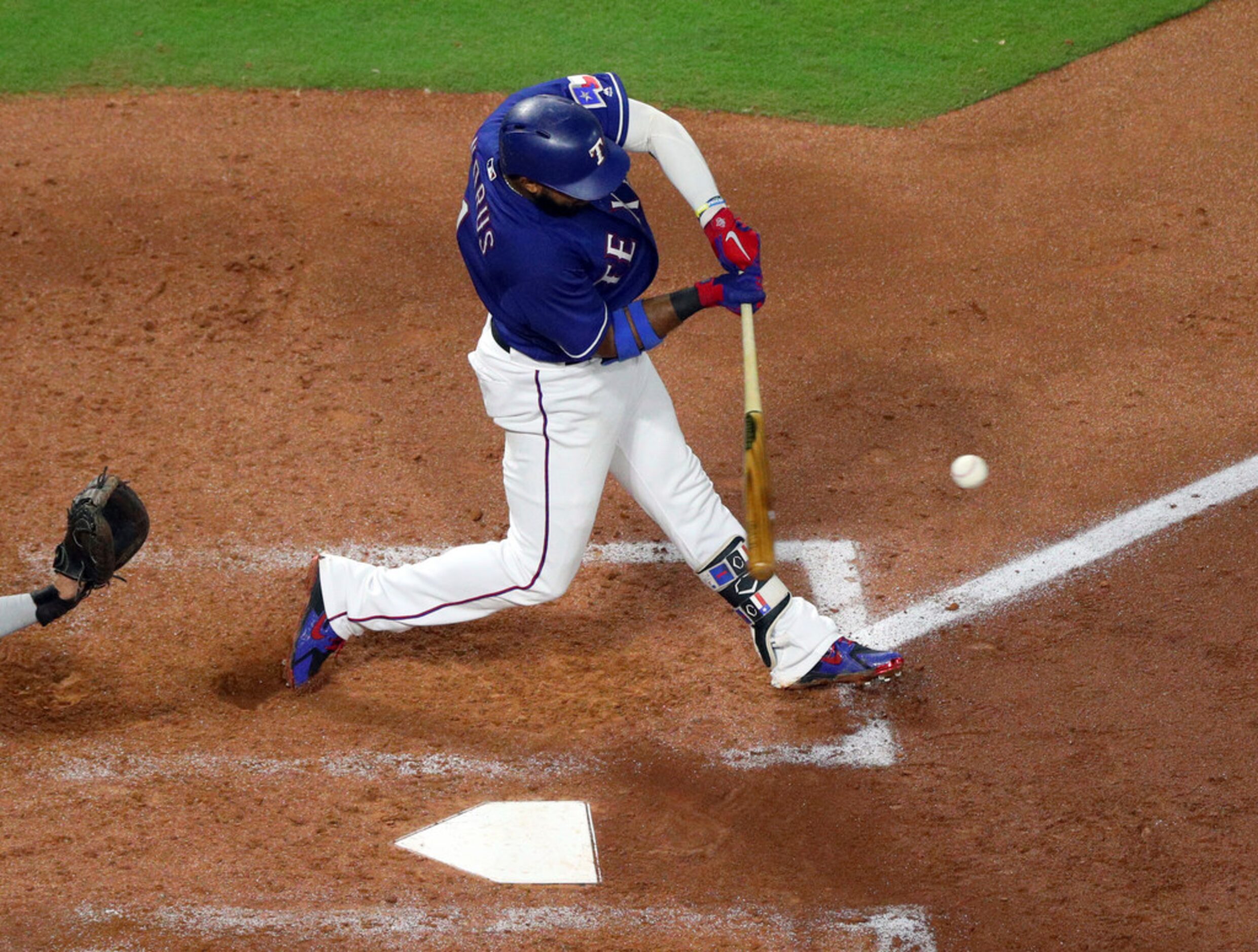 Texas Rangers' Elvis Andrus (1) connects for a home run in the fourth inning in a baseball...