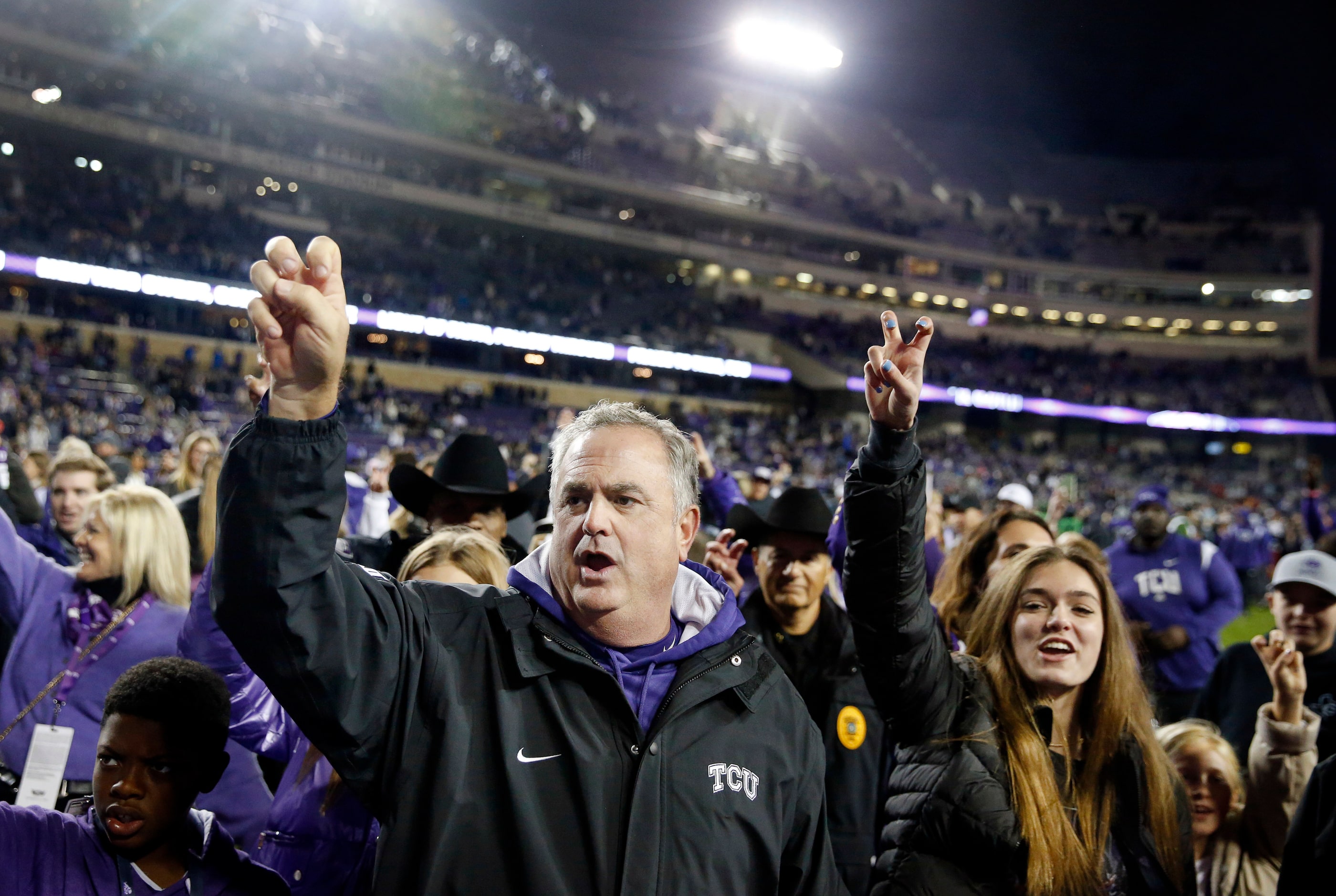 TCU Horned Frogs head coach Sonny Dykes celebrates the team's 62-14 win with family at Amon...