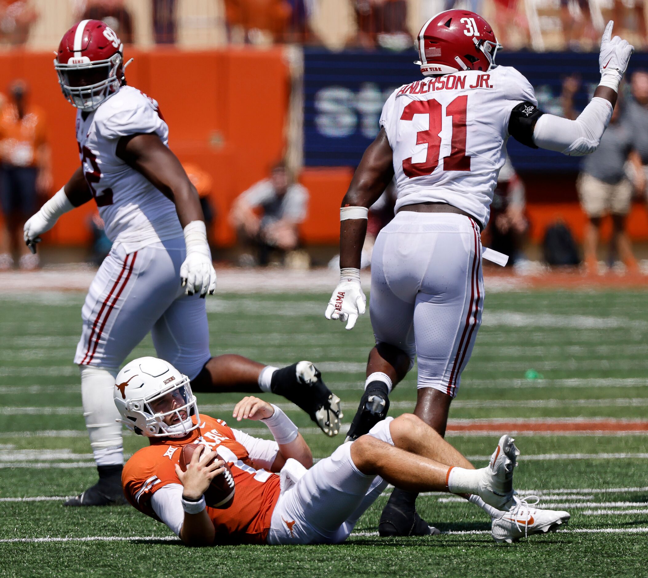 Texas Longhorns quarterback Hudson Card (1) goes down after Alabama Crimson Tide defensive...