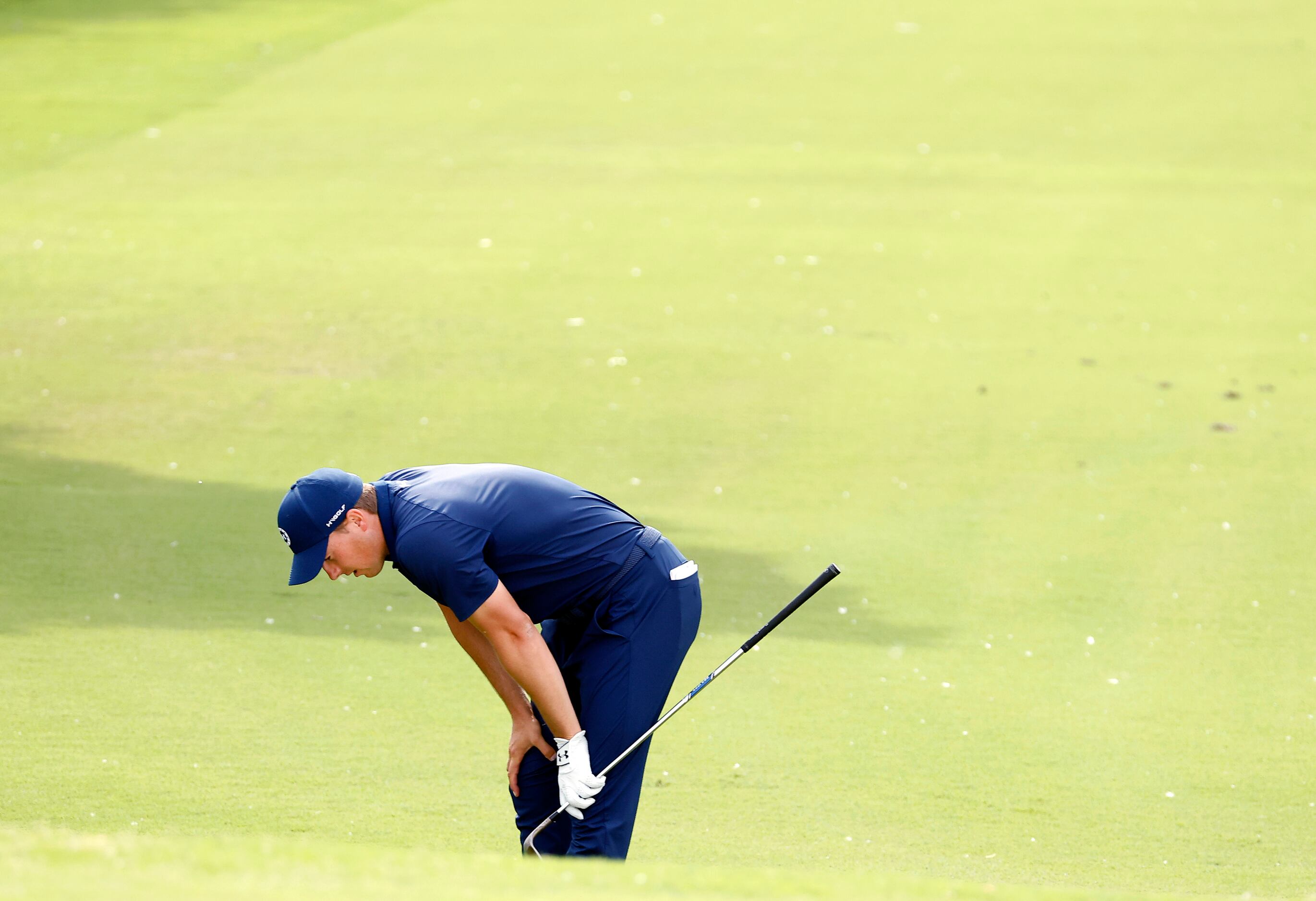 Professional golfer Jordan Spieth reacts after his chip shot onto No. 15 was long during the...