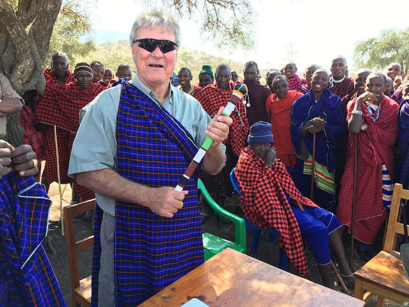 Trevor Rees-Jones holds a Maasai chief's staff outside a school in Tanzania. Tribal elders...