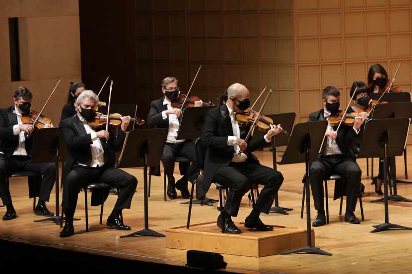 The Dallas Symphony Orchestra, led by concertmaster Alexander Kerr, center, performs at the...