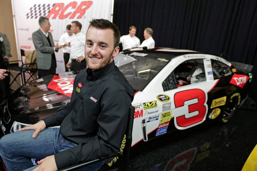 Austin Dillon smiles as he waits to be interviewed in front of the car he will drive in the...