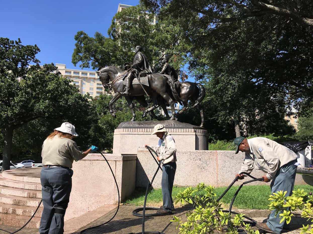 A city parks crew packed up power-washing equipment after cleaning the statue of Robert E....