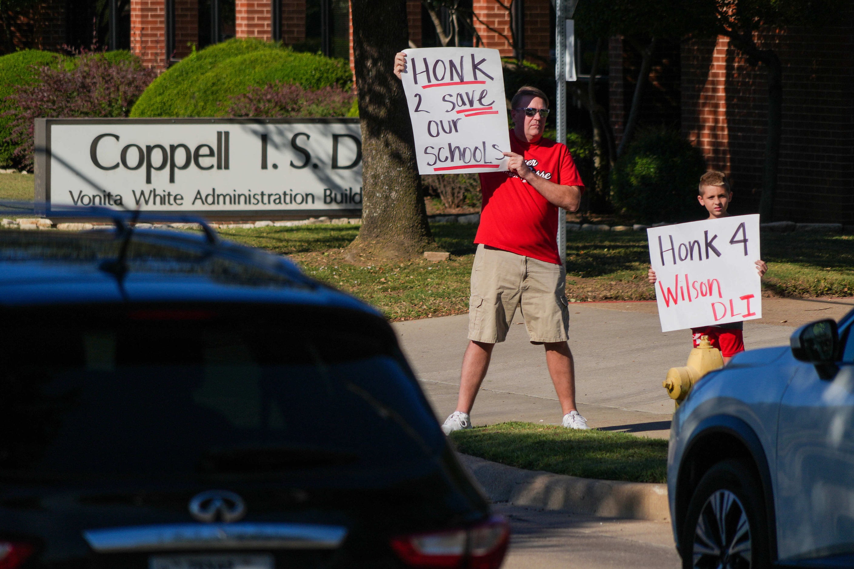 Robert (left) and Vance Hill protest outside the Coppell ISD administration building on...